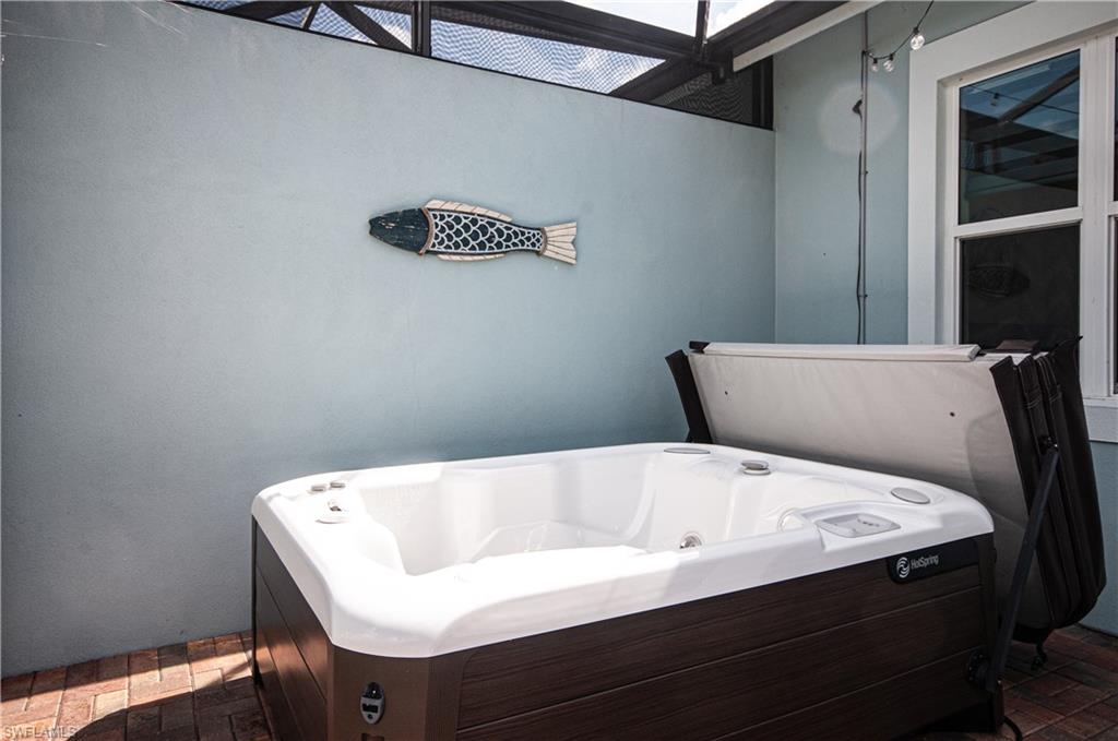 5827 Haiti Drive Naples, FL 34113 - Photo 24 of 29 a bath tub sitting in a bathroom next to a window