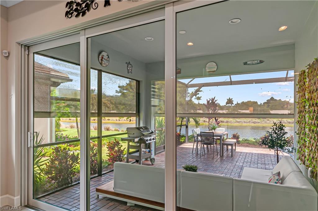 5827 Haiti Drive Naples, FL 34113 - Photo 28 of 29 a dining room with wooden floor and a floor to ceiling window