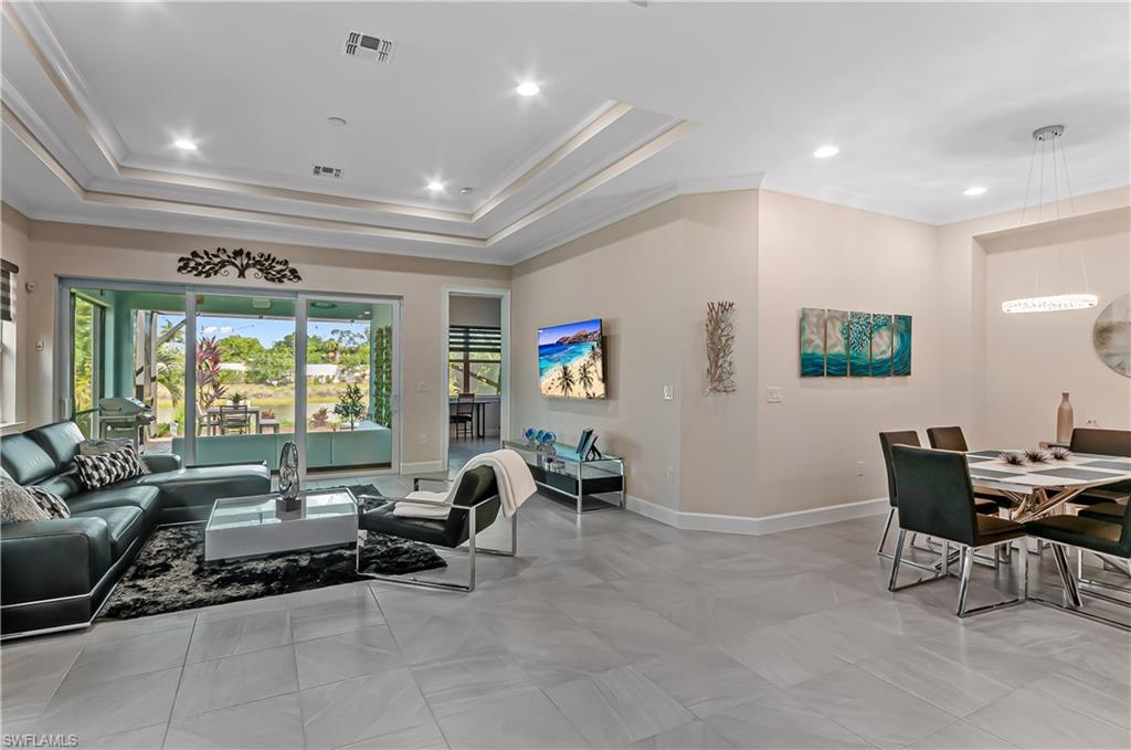 5827 Haiti Drive Naples, FL 34113 - Photo 5 of 29 a living room with furniture and large windows