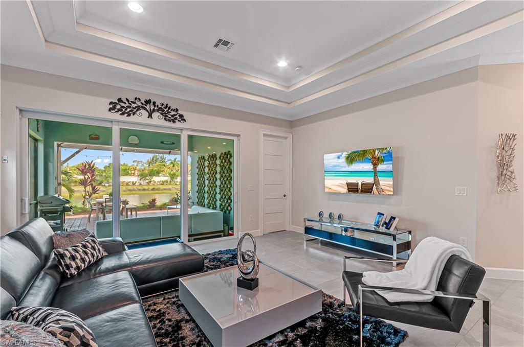 5827 Haiti Drive Naples, FL 34113 - Photo 6 of 29 a living room with furniture and a flat screen tv