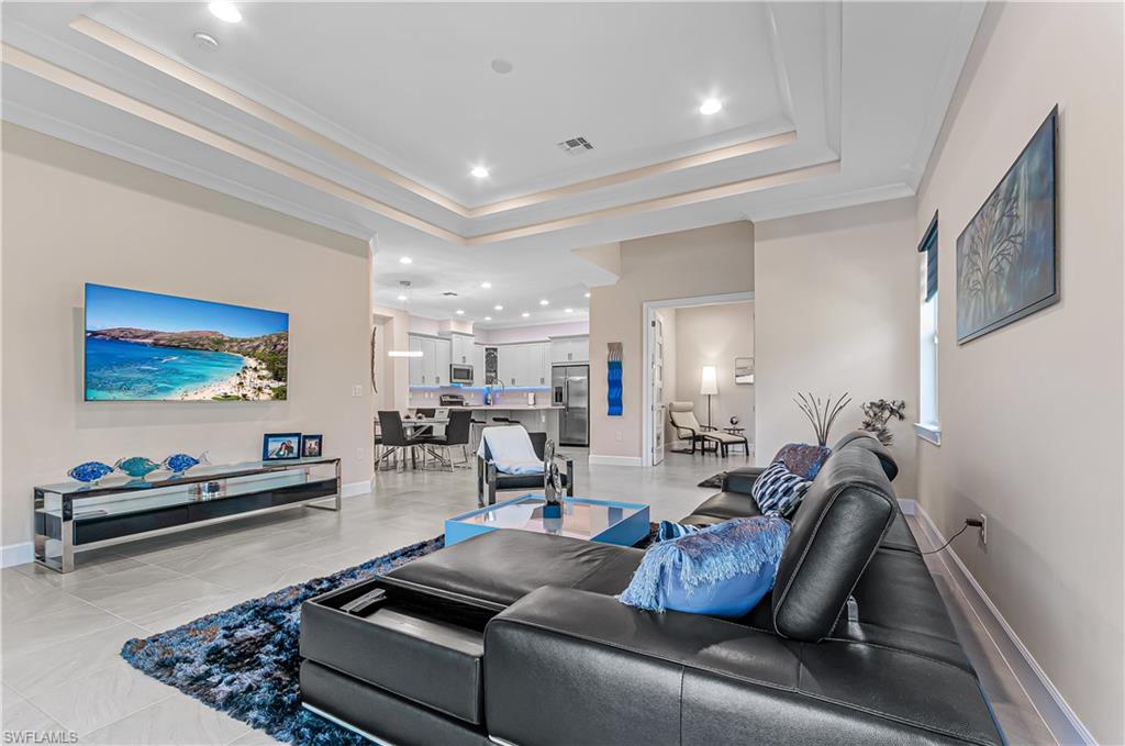 5827 Haiti Drive Naples, FL 34113 - Photo 7 of 29 a living room with furniture and a flat screen tv
