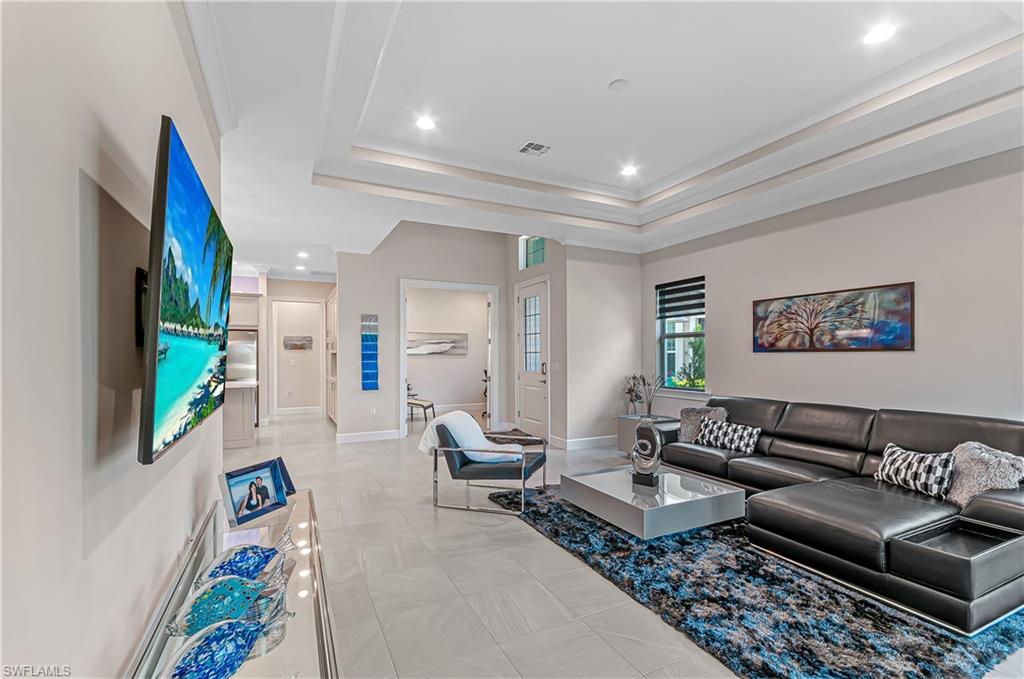 5827 Haiti Drive Naples, FL 34113 - Photo 8 of 29 a living room with furniture and a flat screen tv