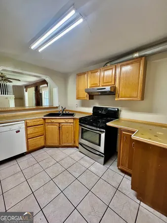a kitchen with a sink cabinets and window
