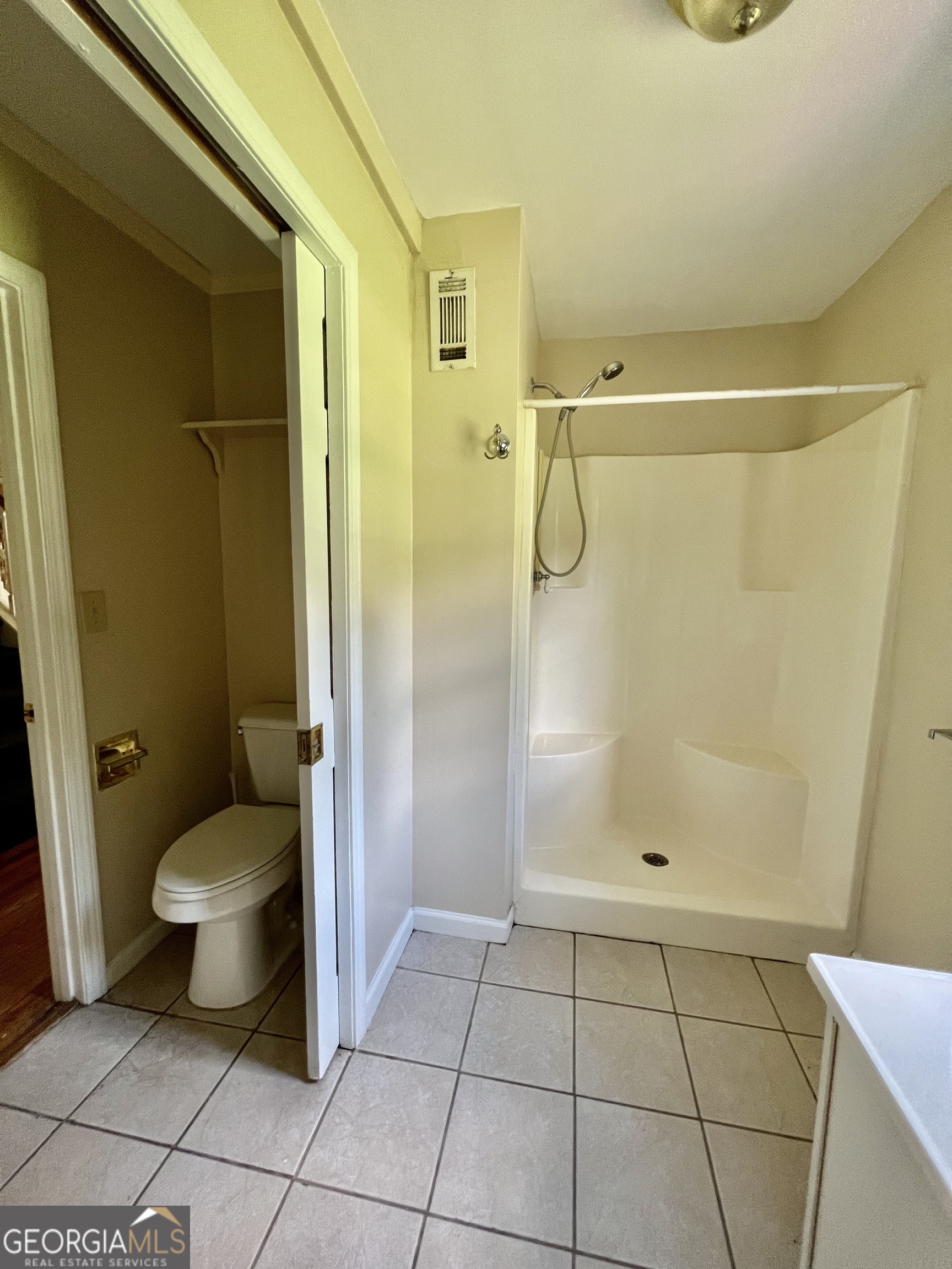 112 Cherry Lane Athens, GA 30601 - Photo 5 of 11 a bathroom with a granite countertop shower and a toilet