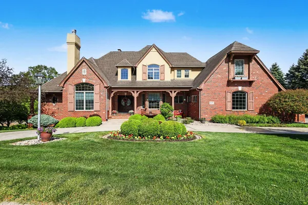 a front view of house with yard and green space