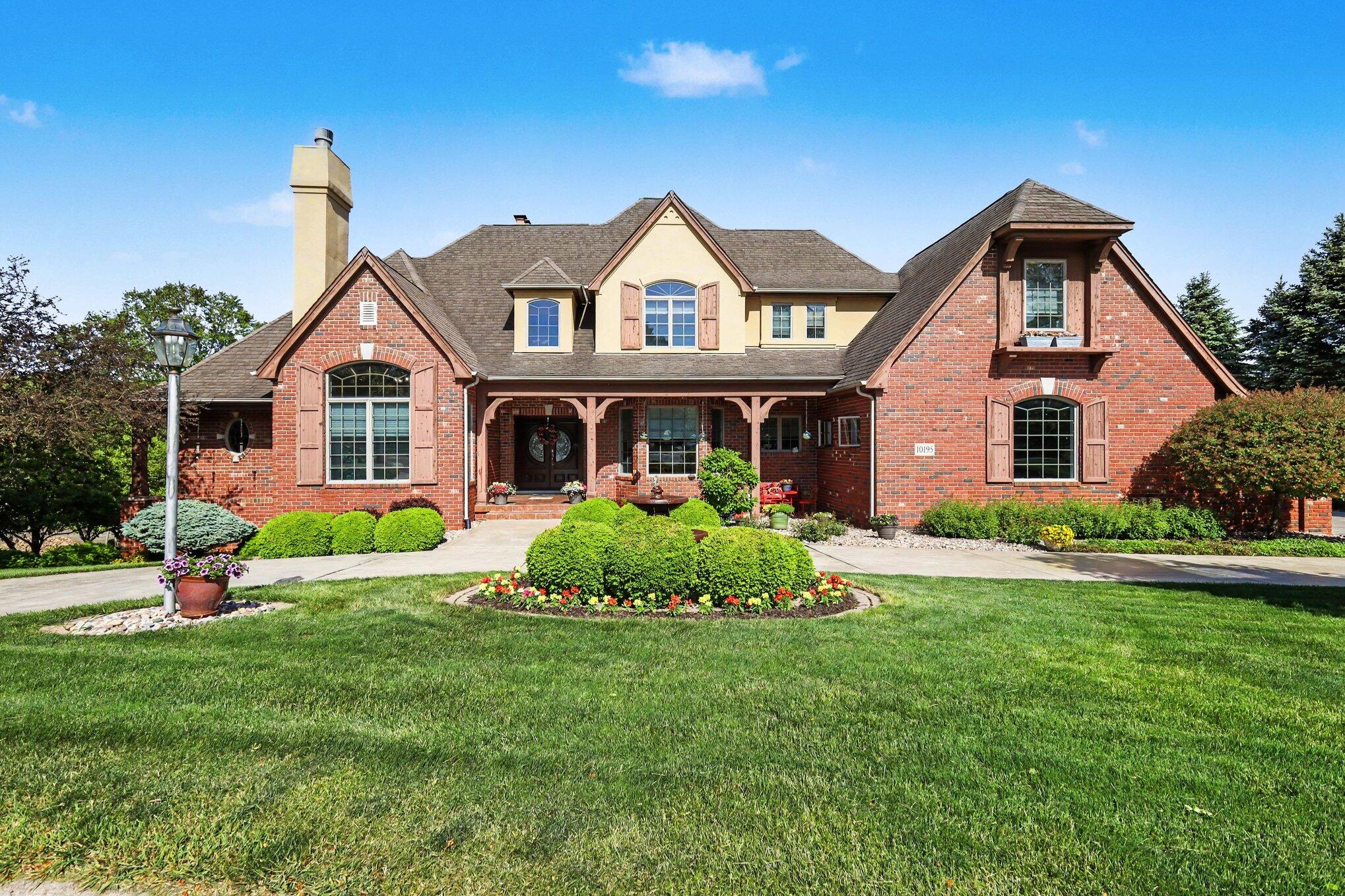a front view of house with yard and green space