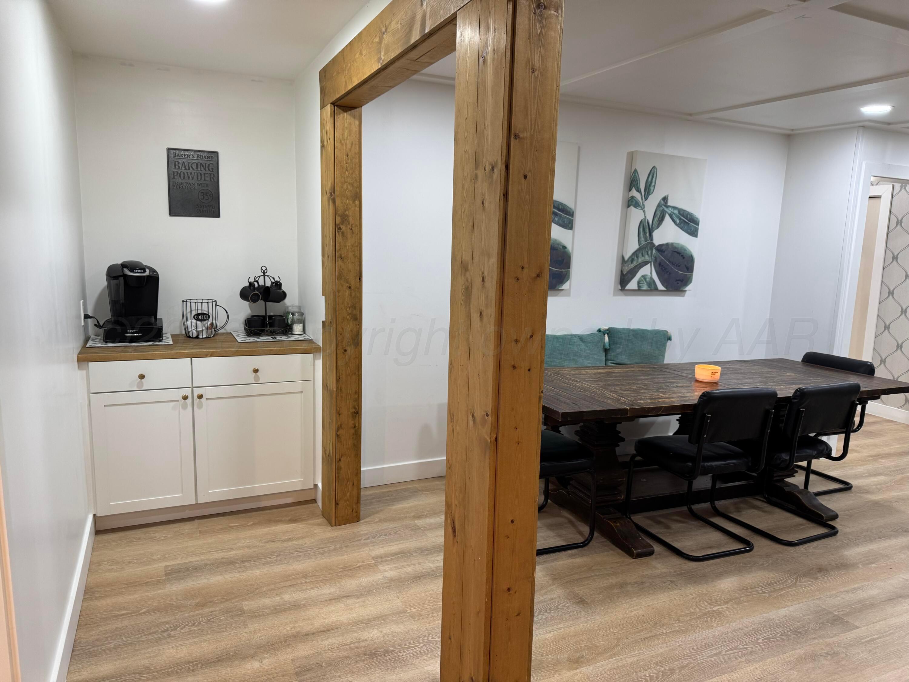 211 South 7th Street Canadian, TX 79014 - Photo 4 of 11 a view of a workspace with furniture and wooden floor