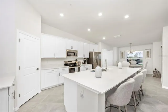 a kitchen with a sink stove top oven and cabinets