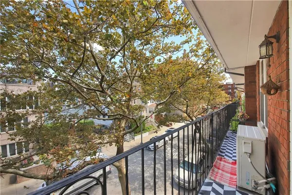 a view of balcony with wooden floor and fence