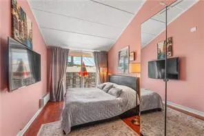 a bedroom with a bed a flat screen tv and balcony