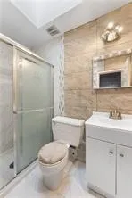 a bathroom with a sink toilet and shower