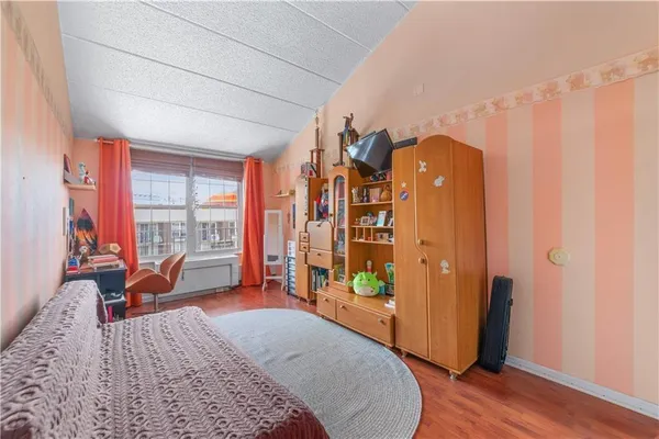 a bed room with a bed and a window