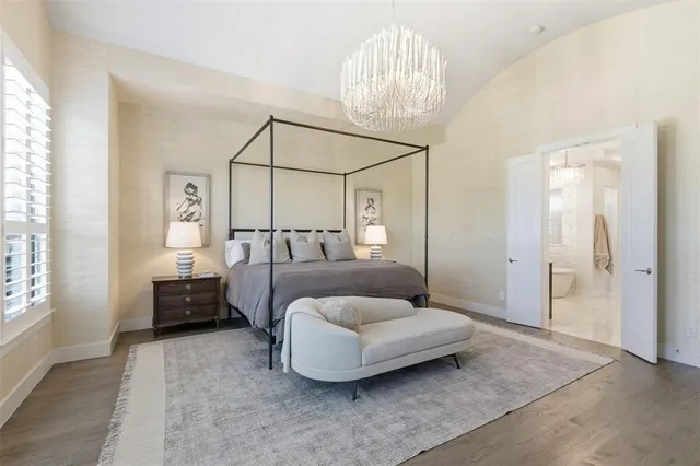 a bedroom with a bed and a chandelier