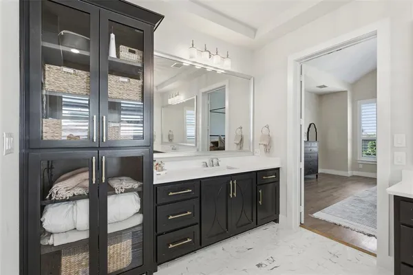 a spacious bathroom with a granite countertop sink and a mirror