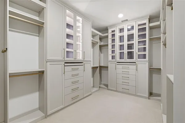 a view of walk in closet with windows