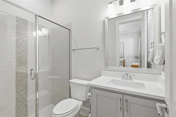 a bathroom with a sink toilet and shower