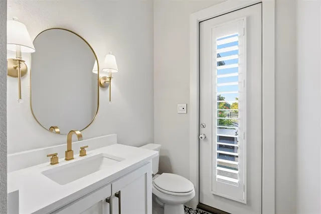 a bathroom with a toilet a sink and a mirror