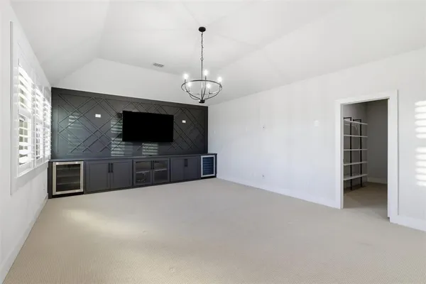 a view of an empty room with a kitchen