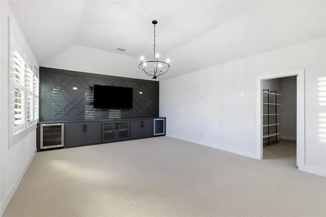 a view of an empty room with a kitchen