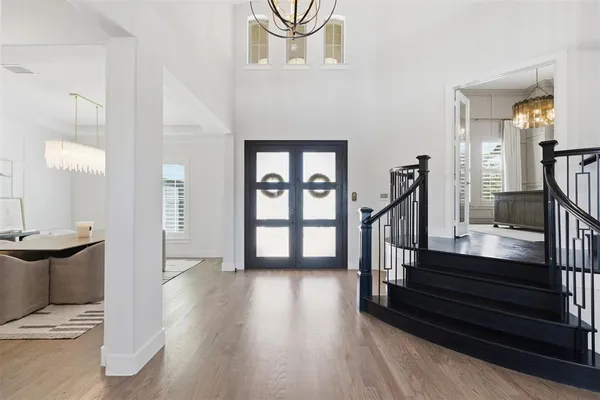 a view of entryway and hall with wooden floor