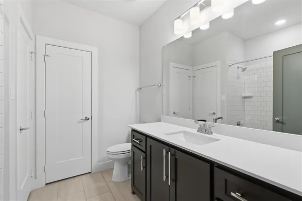 a bathroom with a sink a toilet and a mirror