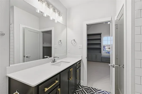 a bathroom with a sink vanity and a mirror