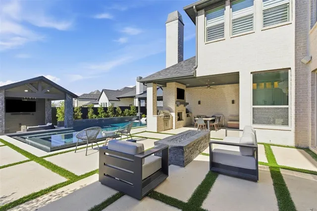 a view of a house with swimming pool and sitting area