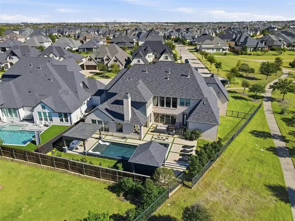 an aerial view of a house with a big yard
