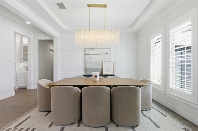 a view of a a dining room with furniture window and wooden floor