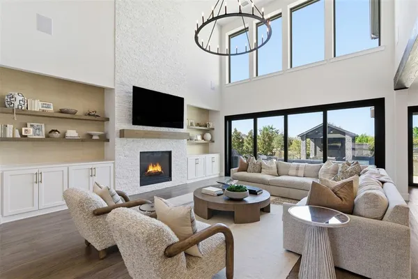 a living room with furniture a flat screen tv and a fireplace