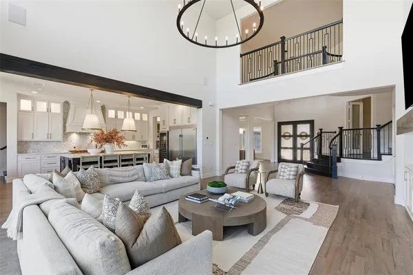 a living room with furniture fireplace and a large window