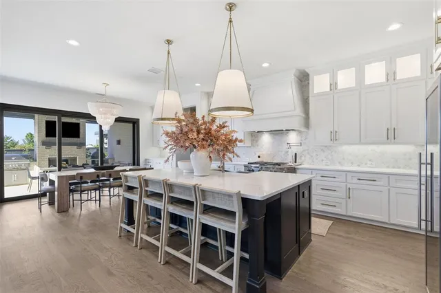 a kitchen with kitchen island granite countertop a sink a center island and cabinets