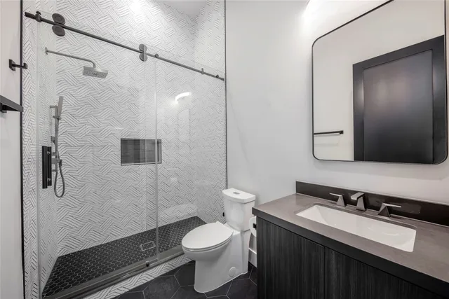 a bathroom with a tub sink mirror and shower