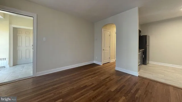 an empty room with wooden floor and closet