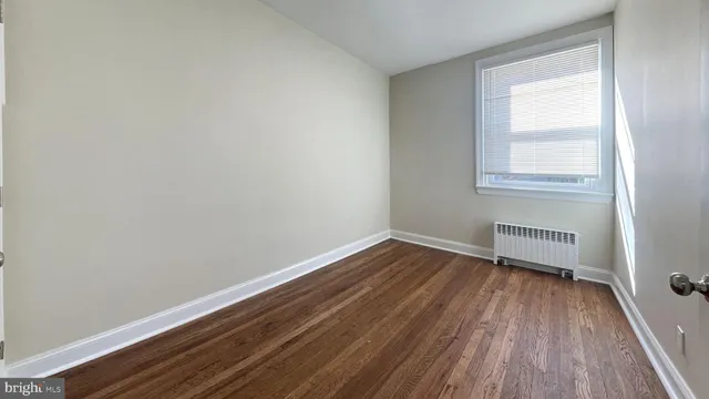 a view of a room with wooden floor and window