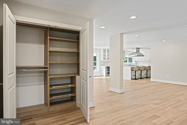 an empty room with wooden floor and sliding door