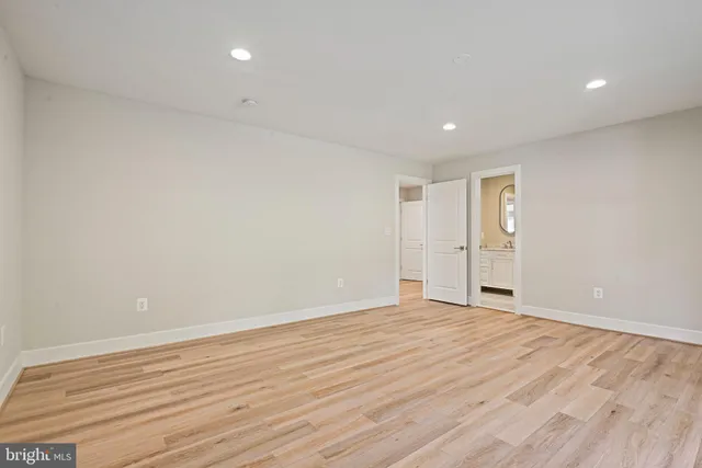 a view of a empty room with cabinet and mirrors