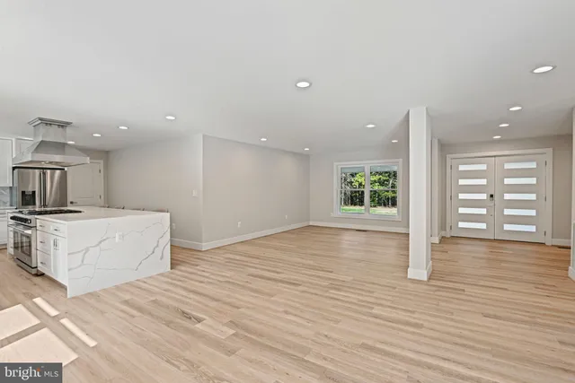 a view of a livingroom with wooden floor and a fireplace
