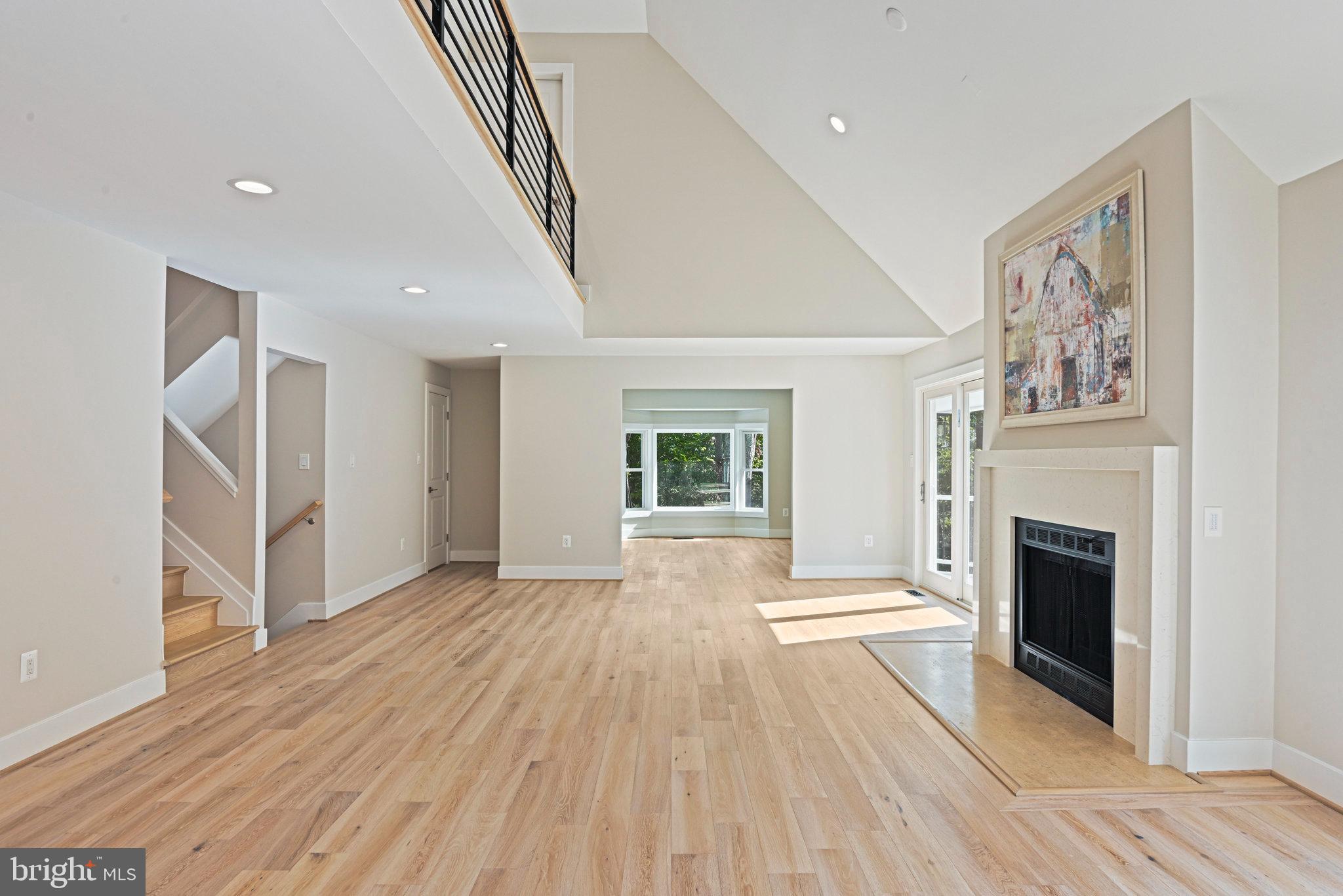 10900 Hunter Station Road Vienna, VA 22181 - Photo 27 of 110 a view of a livingroom with wooden floor and a fireplace