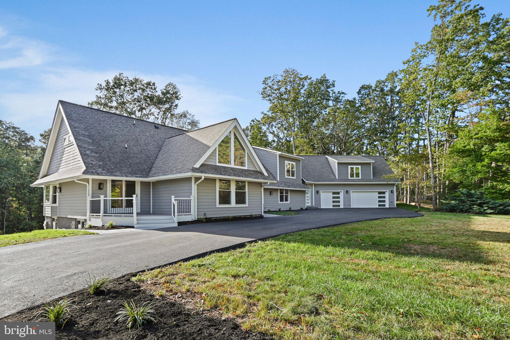 10900 Hunter Station Road Vienna, VA 22181 - Photo 4 of 110 front view of a house with a garden