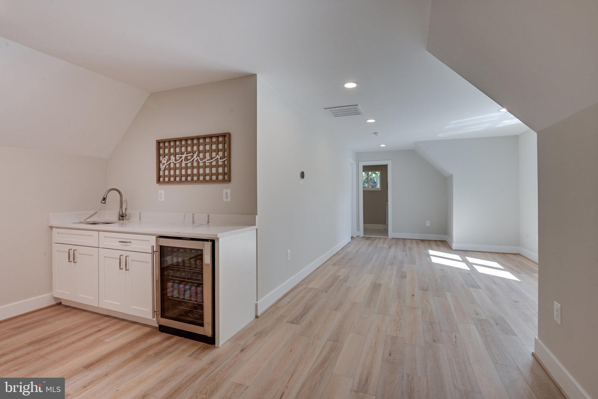 10900 Hunter Station Road Vienna, VA 22181 - Photo 46 of 110 a view of a kitchen with sink and wooden floor
