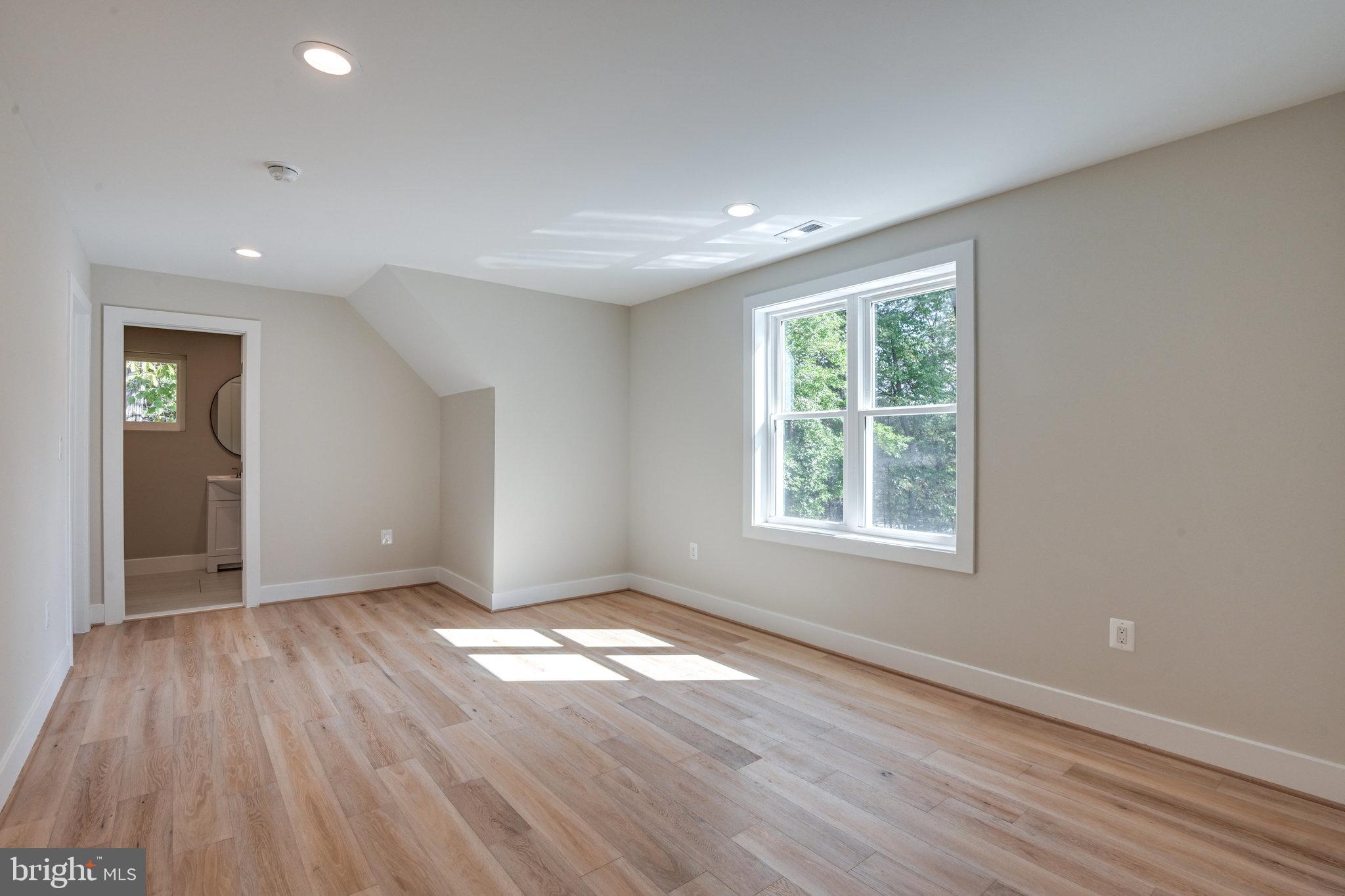 10900 Hunter Station Road Vienna, VA 22181 - Photo 47 of 110 an empty room with wooden floor and windows