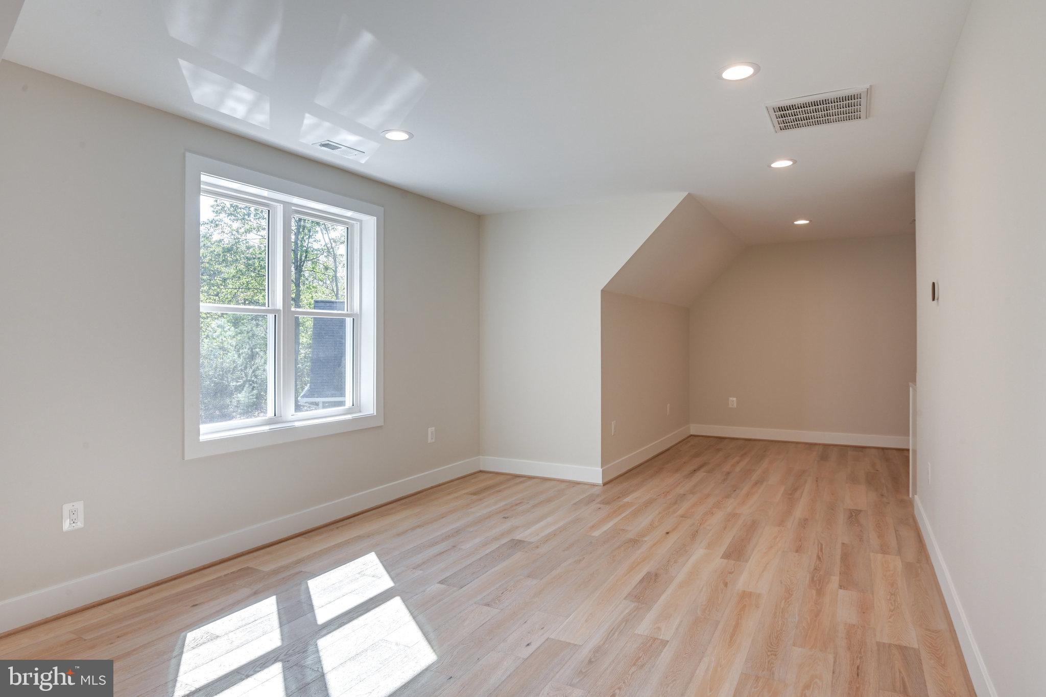 10900 Hunter Station Road Vienna, VA 22181 - Photo 48 of 110 a view of an empty room with wooden floor and a window