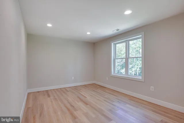a view of a house with a yard and potted plants