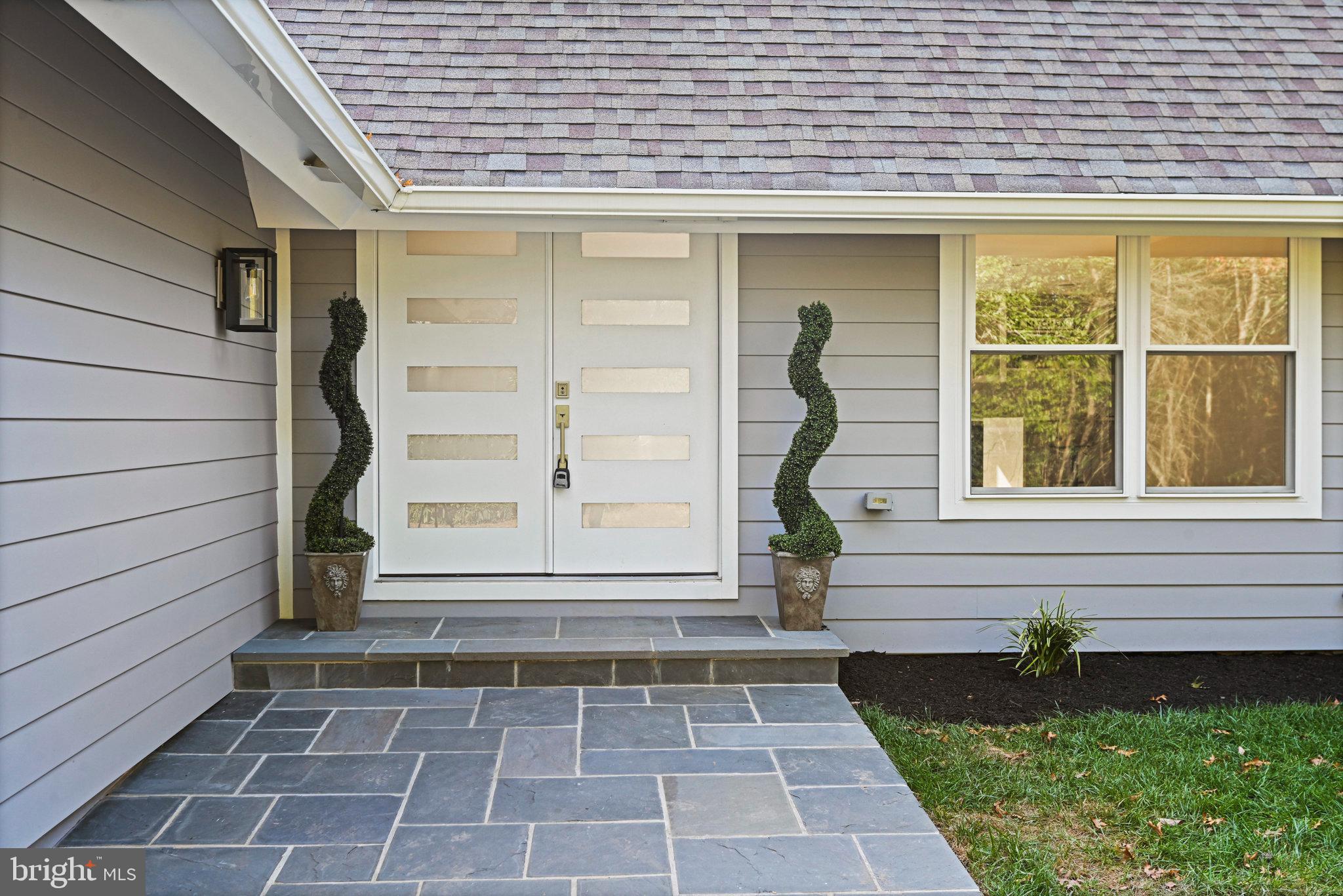 10900 Hunter Station Road Vienna, VA 22181 - Photo 5 of 110 a front view of a house with a garden