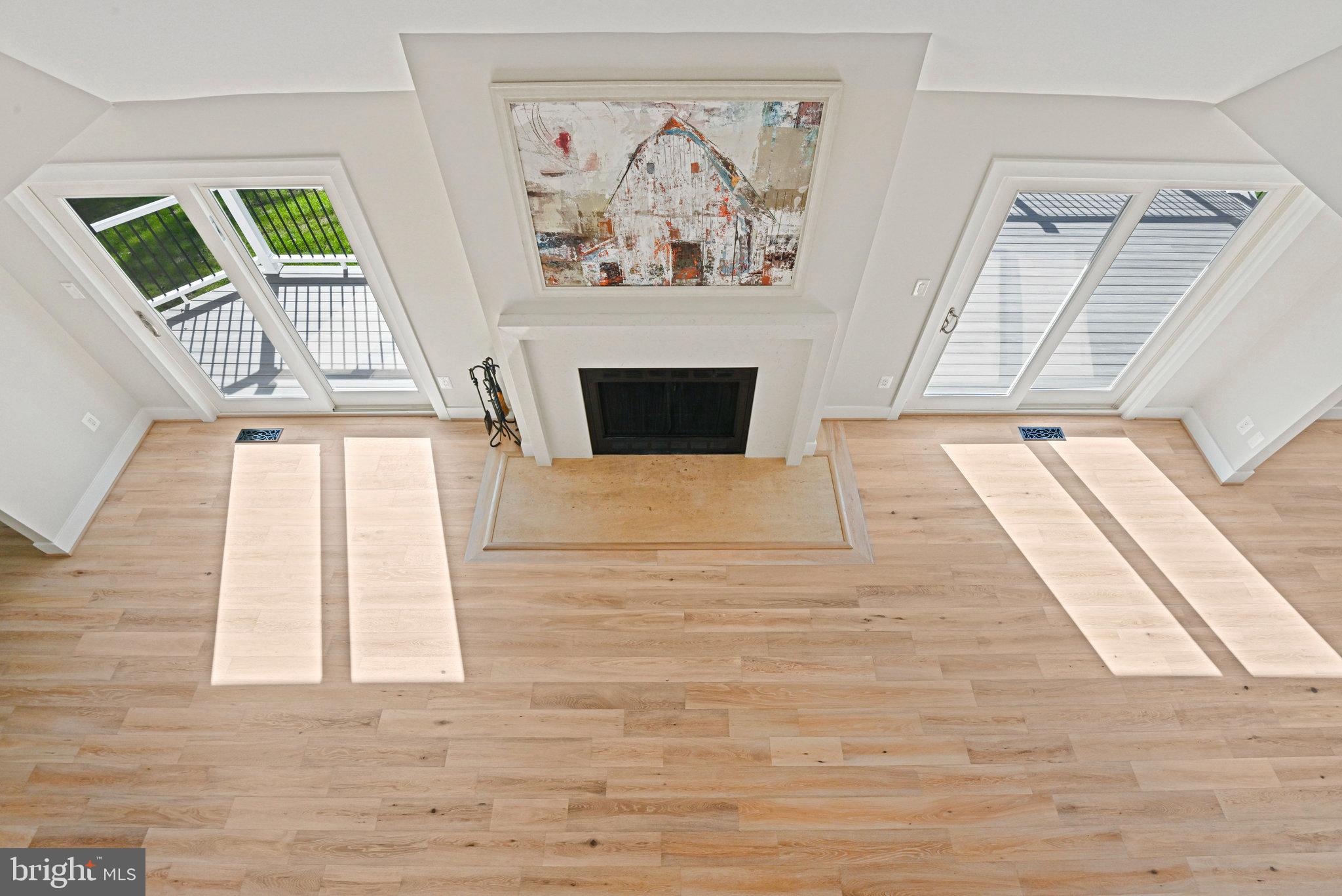 10900 Hunter Station Road Vienna, VA 22181 - Photo 53 of 110 a view of a livingroom with wooden floor and a fireplace