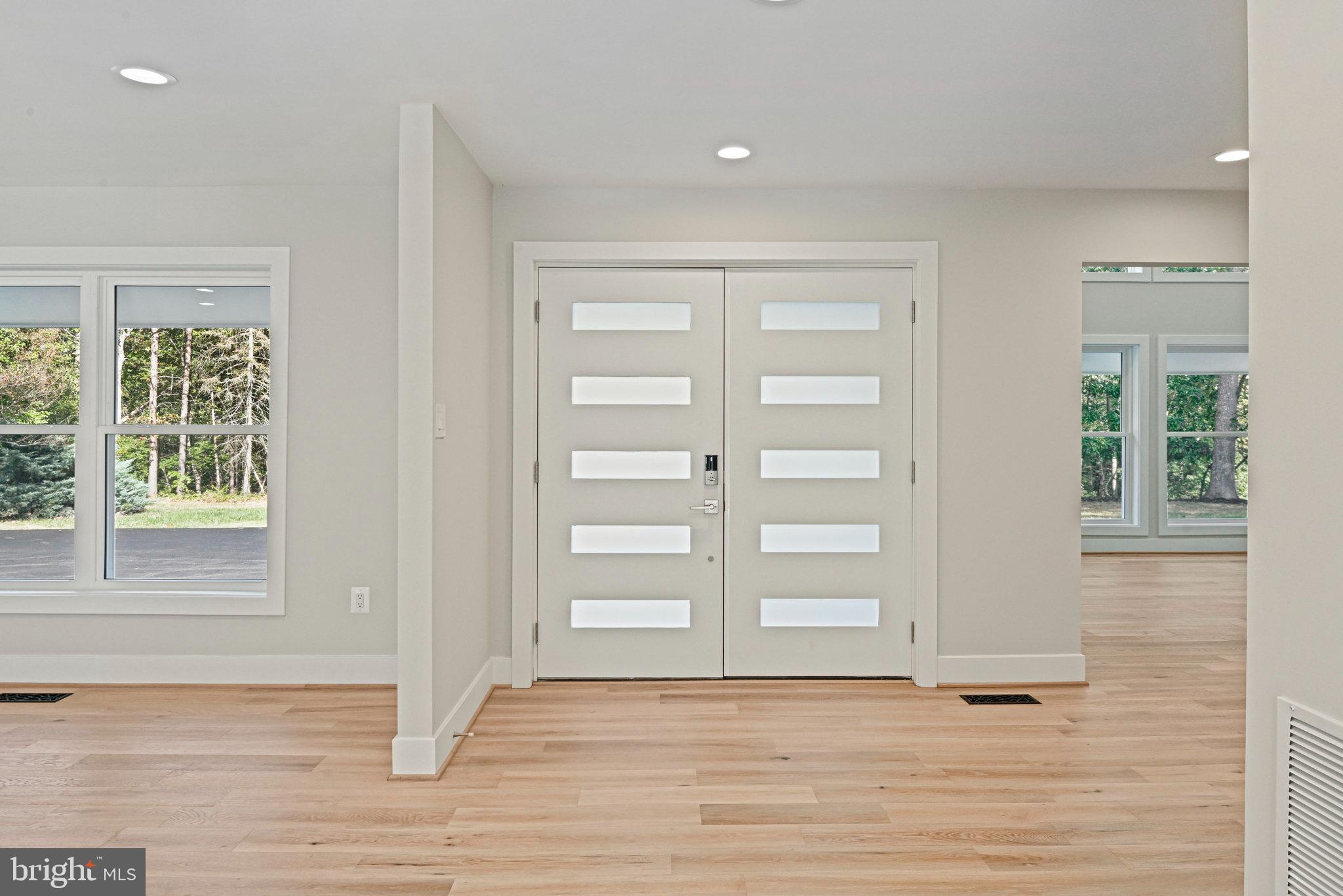 10900 Hunter Station Road Vienna, VA 22181 - Photo 6 of 110 a view of an empty room with a window and wooden floor