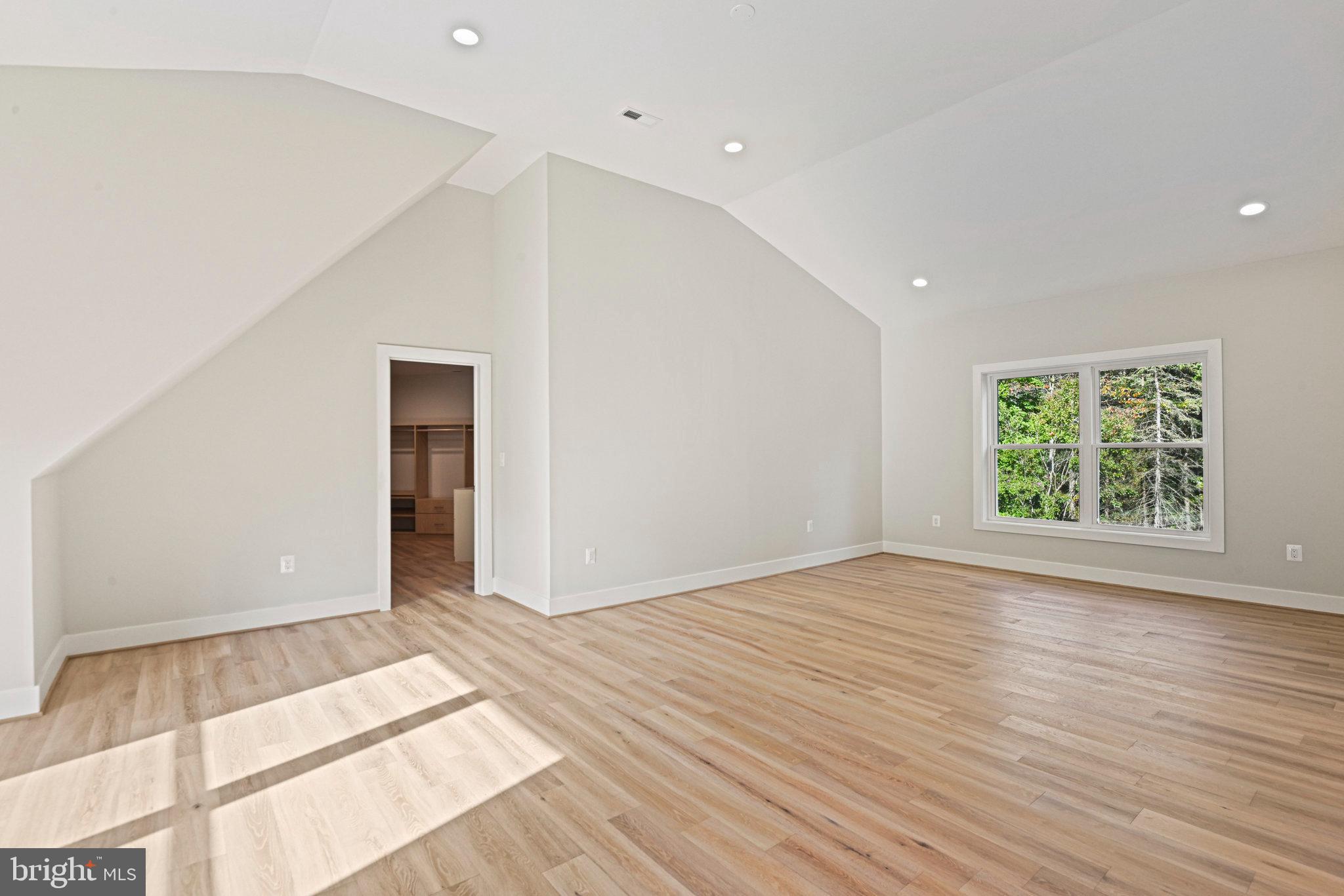 10900 Hunter Station Road Vienna, VA 22181 - Photo 66 of 110 an empty room with wooden floor and window
