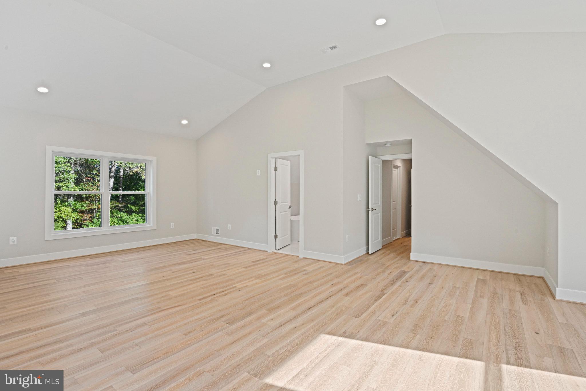 10900 Hunter Station Road Vienna, VA 22181 - Photo 68 of 110 a view of an empty room with wooden floor and a window