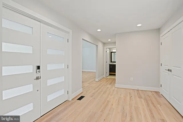 a view of an empty room with wooden floor
